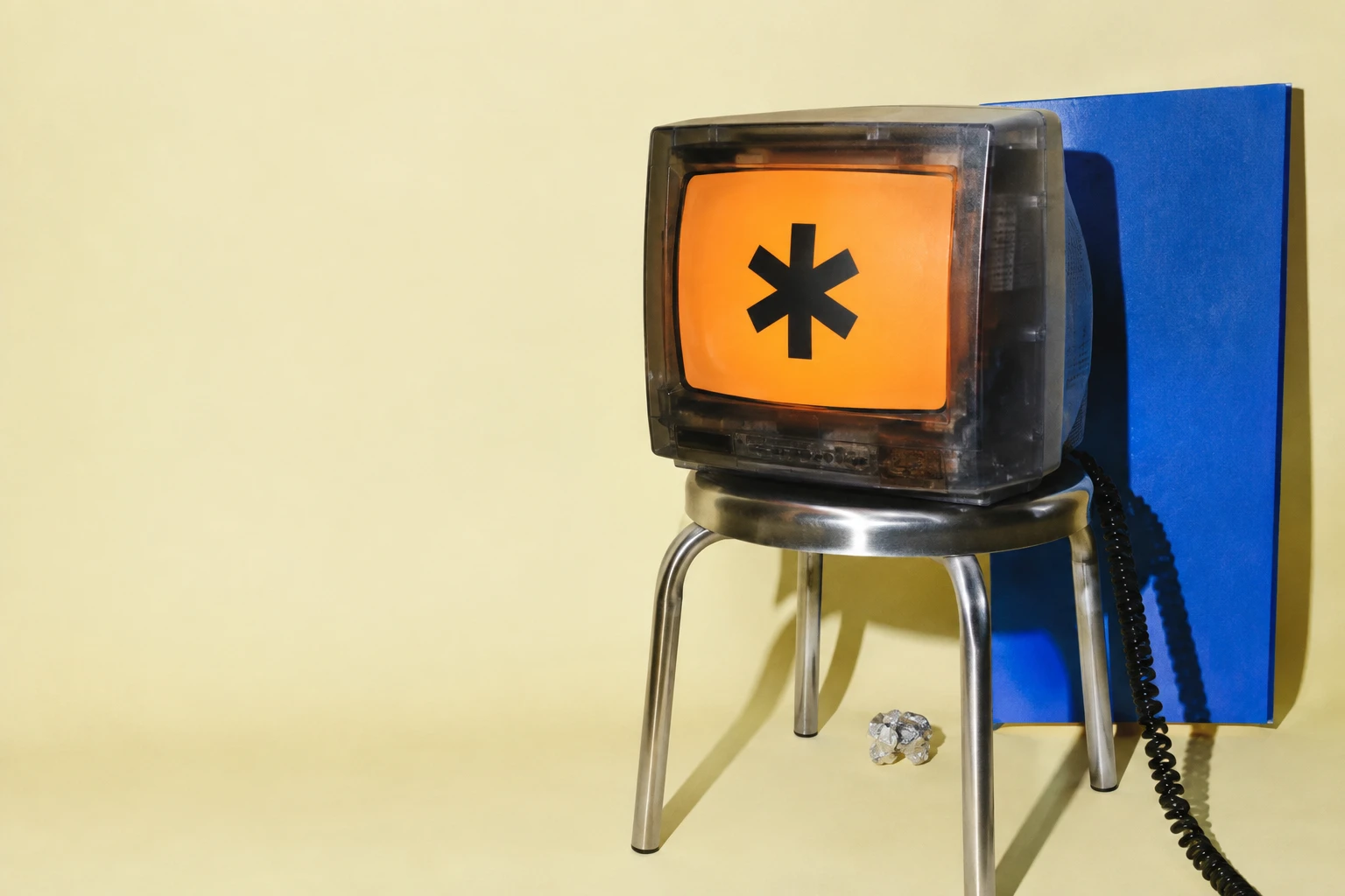 Vintage monitor with an orange screen on a chrome stool