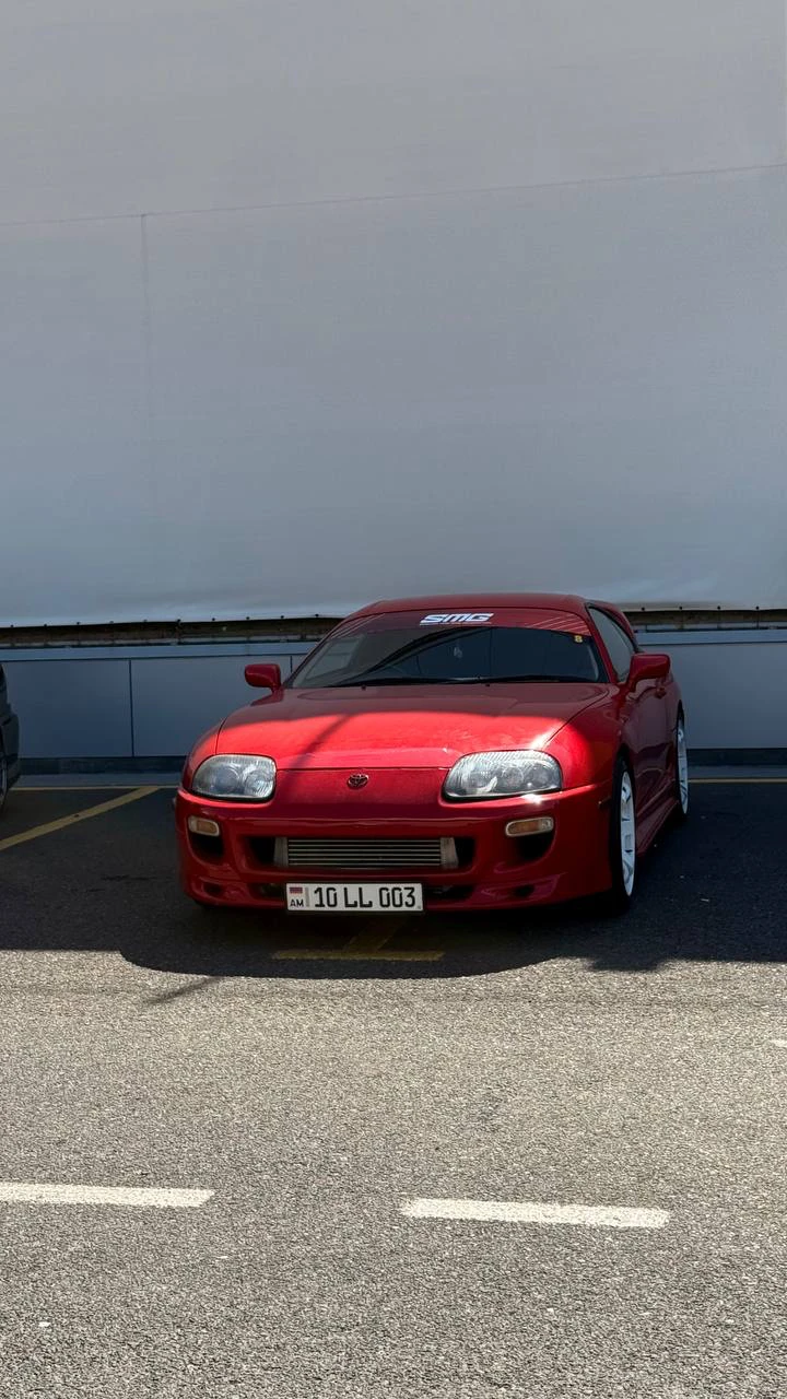 Red Toyota Supra, front view before editing